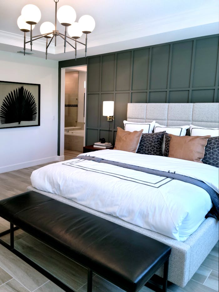 Contemporary bedroom featuring a stylish bed, lighting, and decor elements for a luxurious feel.
